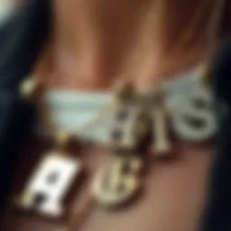 A close-up view of layered initial necklaces featuring various designs and textures