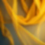 Elegant draping of a gold organza shawl showcasing its sheer texture