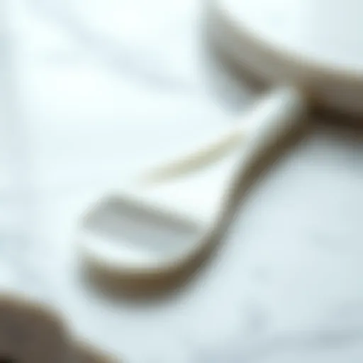 Close-up of a face scraper on a marble surface, highlighting its sleek design.