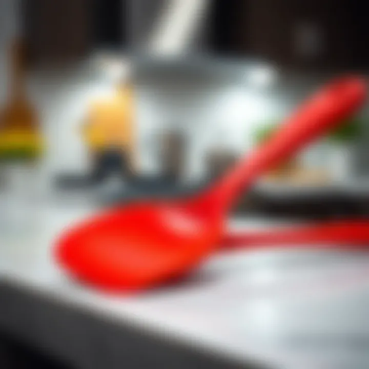 Vibrant red silicone spatula resting on a modern kitchen countertop