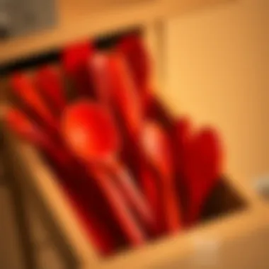 A collection of red silicone utensils arranged artistically in a kitchen drawer
