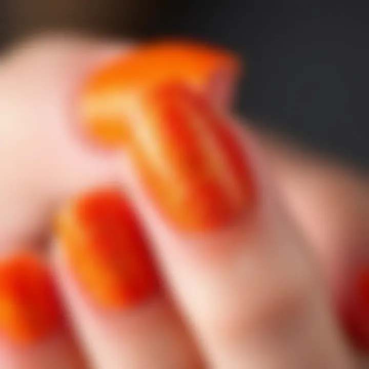 Close-up shot of orange glitter dip powder applied on nails