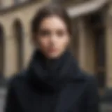 Elegant black scarf styled with a classic coat