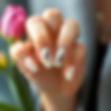 A beautifully designed nail art piece complementing nude acrylic nails