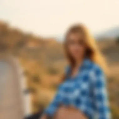 A scenic outdoor setting where a woman confidently wears a white and blue plaid shirt.